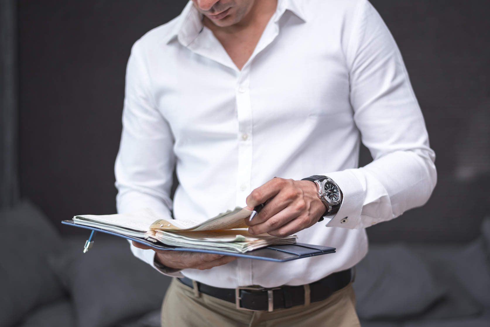 Man in White Dress Shirt Holding a Planner